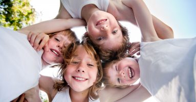 Happy children in white shirts in the sky